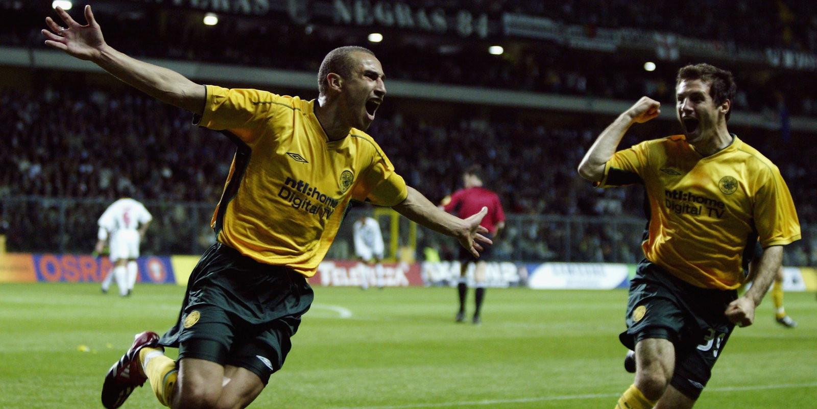 Henrik Larsson of Celtic celebrates scoring